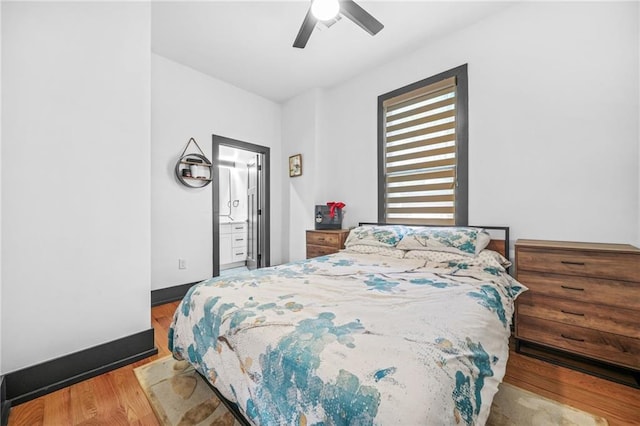 bedroom featuring a ceiling fan, wood finished floors, and baseboards