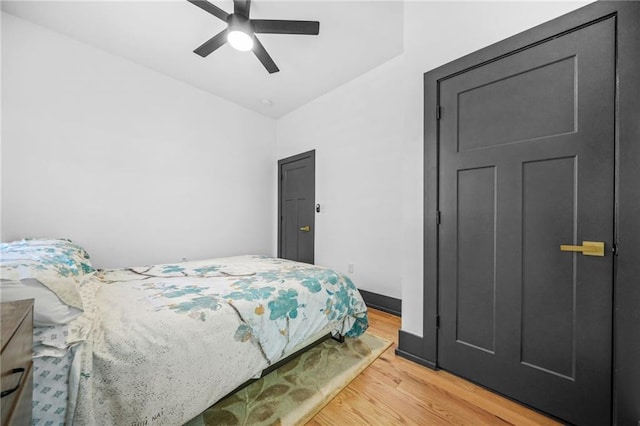 bedroom featuring a ceiling fan, light wood-type flooring, and baseboards