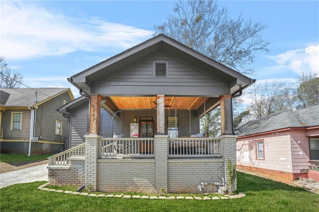 view of front of house featuring a front yard and covered porch