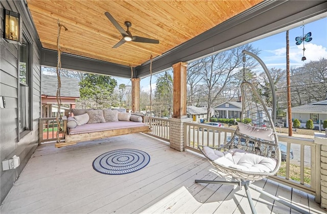 wooden deck featuring a porch and ceiling fan