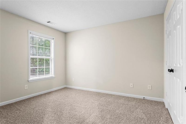 spare room featuring carpet flooring