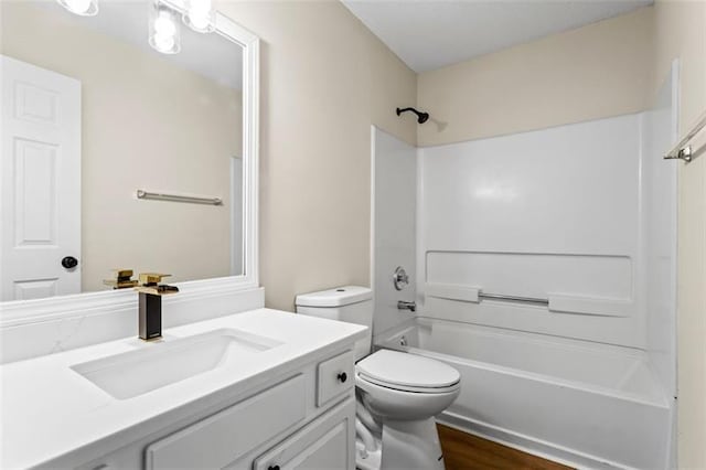 full bathroom with hardwood / wood-style flooring, vanity, toilet, and bathing tub / shower combination