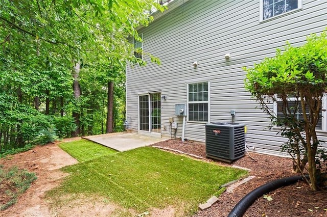 back of house featuring central AC unit, a yard, and a patio