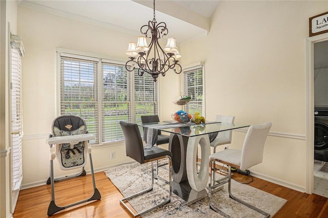 1644 Beaver Creek Ln, Snellville, GA 30078 - dining room with a chandelier, healthy amount of natural light, baseboards, wood finished floors, and ornamental molding