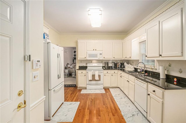1644 Beaver Creek Ln, Snellville, GA 30078 - kitchen with white appliances, a sink, dark countertops, ornamental molding, and backsplash