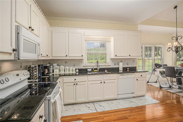 1644 Beaver Creek Ln, Snellville, GA 30078 - kitchen with white appliances, a sink, a chandelier, ornamental molding, and light wood-style flooring