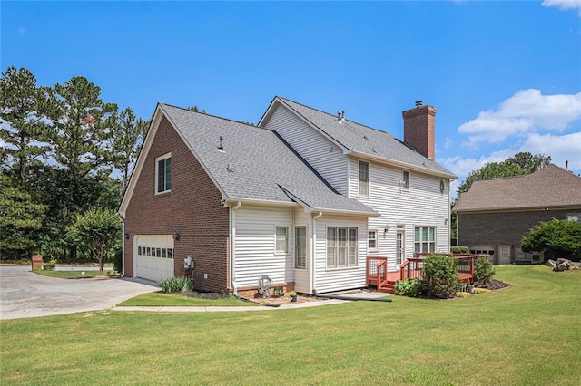 1644 Beaver Creek Ln, Snellville, GA 30078 - back of property featuring a chimney, driveway, a wooden deck, a yard, and a garage