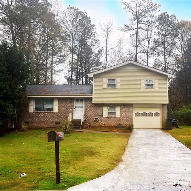 split level home featuring a garage and a front lawn