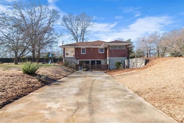 view of front of home with fence and brick siding