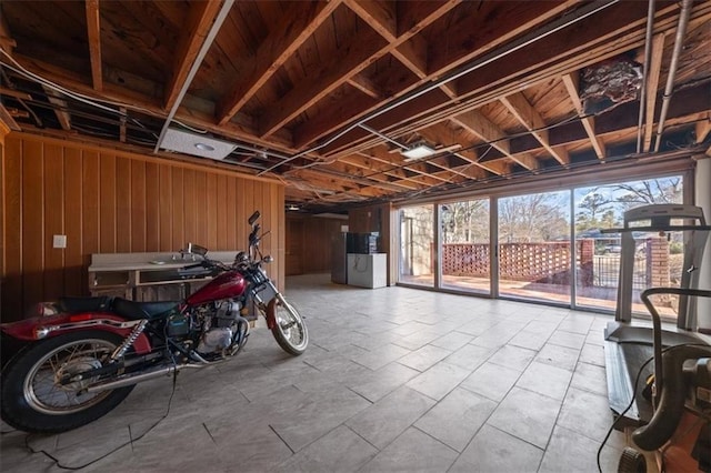 miscellaneous room featuring a garage and wooden walls