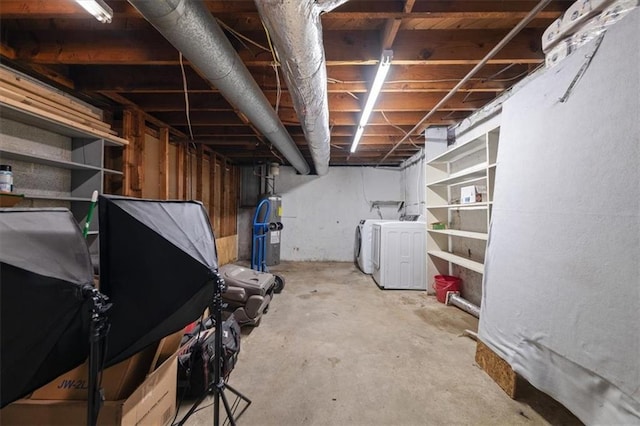 unfinished below grade area with water heater and washing machine and clothes dryer