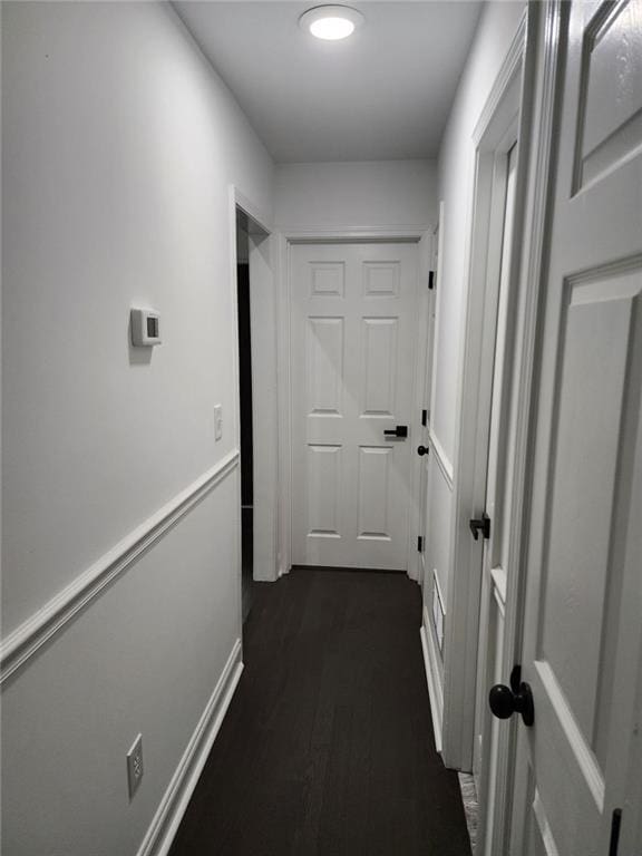 corridor with dark wood-type flooring