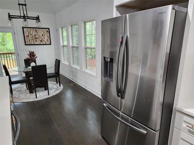 kitchen featuring stainless steel refrigerator with ice dispenser, dark hardwood / wood-style floors, and a wealth of natural light