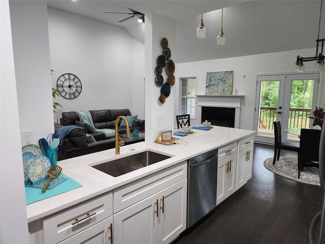 kitchen with white cabinetry, stainless steel dishwasher, hanging light fixtures, and sink