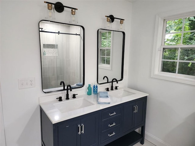 bathroom featuring vanity and a shower with shower door