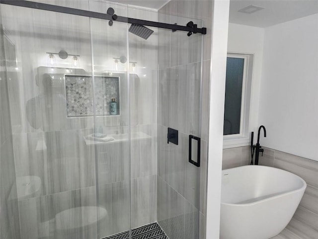 bathroom with tile walls and plus walk in shower