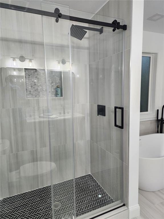 bathroom with shower with separate bathtub