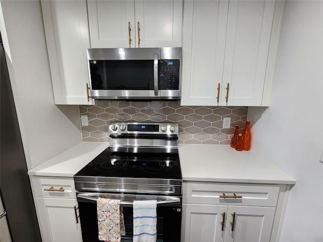 kitchen with white cabinetry, decorative backsplash, and stainless steel appliances