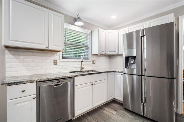 2941 Foothill Trl, Marietta, GA 30066 - kitchen with appliances with stainless steel finishes, white cabinetry, wood finished floors, light stone countertops, and ornamental molding