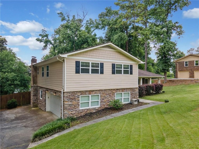 2941 Foothill Trl, Marietta, GA 30066 - tri-level home with an attached garage, asphalt driveway, a chimney, and stone siding
