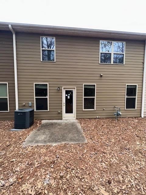 back of property featuring cooling unit and a patio area