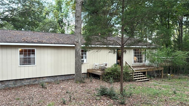 back of house featuring a wooden deck