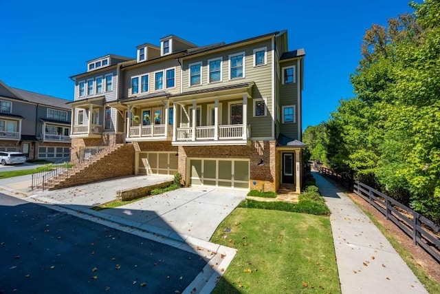 multi unit property featuring brick siding, an attached garage, concrete driveway, and fence