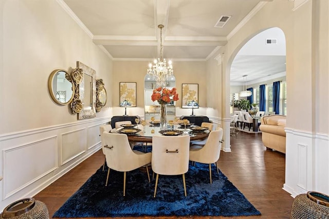 dining area featuring ornamental molding, a chandelier, and dark hardwood / wood-style flooring