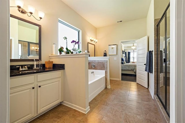 bathroom with vanity, plus walk in shower, and plenty of natural light