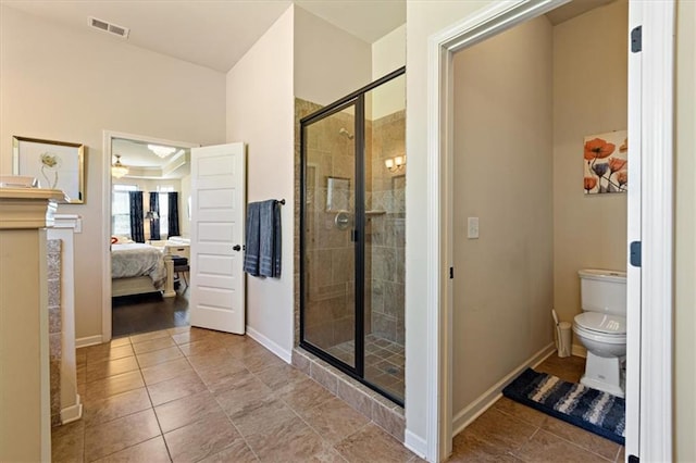 bathroom with tile patterned floors, an enclosed shower, and toilet