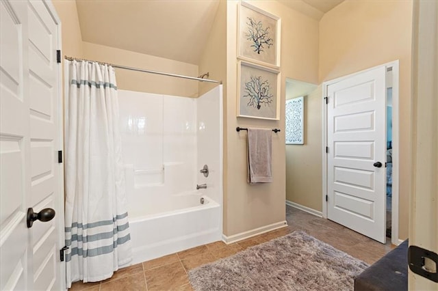 bathroom with shower / bath combination with curtain and tile patterned floors