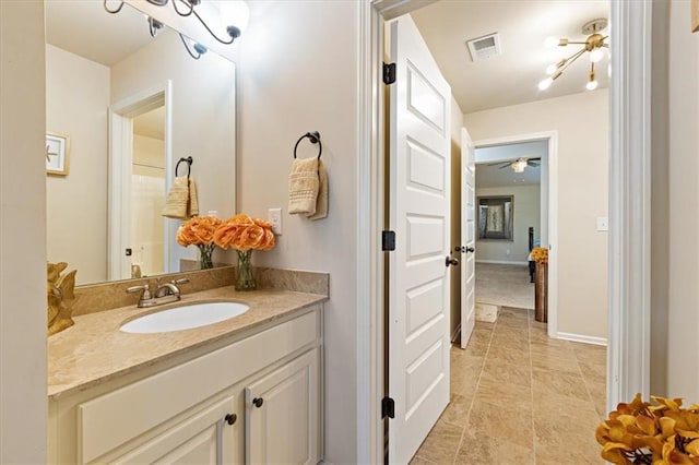 bathroom with ceiling fan and vanity