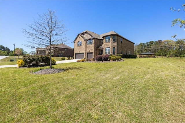 view of front of property featuring a front yard and a garage