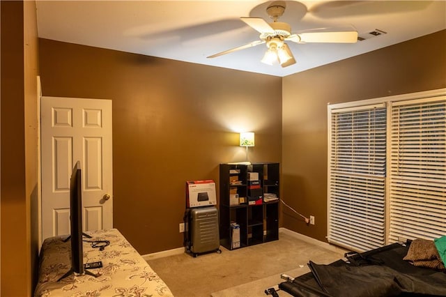 bedroom featuring baseboards, visible vents, ceiling fan, and light colored carpet