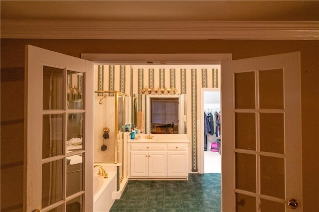 bathroom with vanity, a bathtub, and crown molding