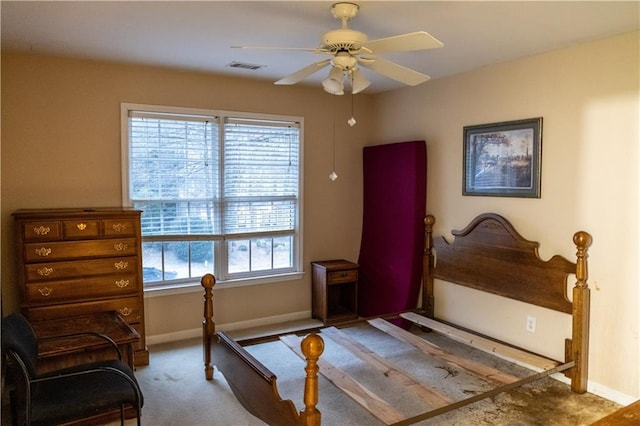 carpeted bedroom featuring baseboards, visible vents, and a ceiling fan