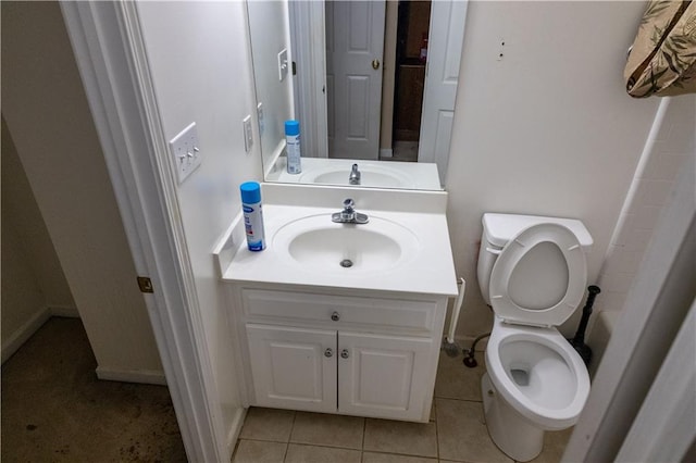 full bathroom featuring toilet, tile patterned floors, and vanity