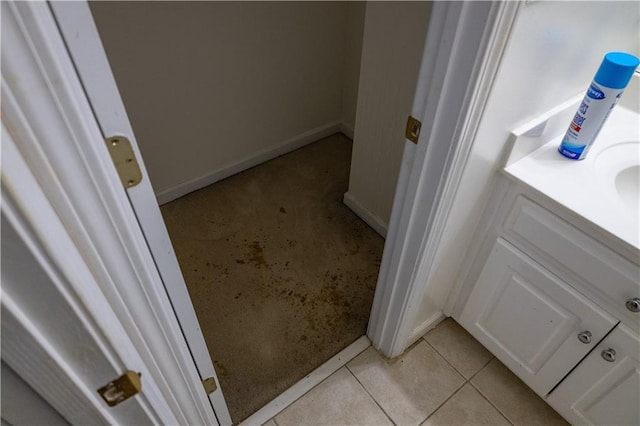 bathroom with tile patterned flooring, vanity, and baseboards