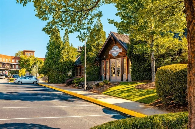 surrounding community featuring uncovered parking
