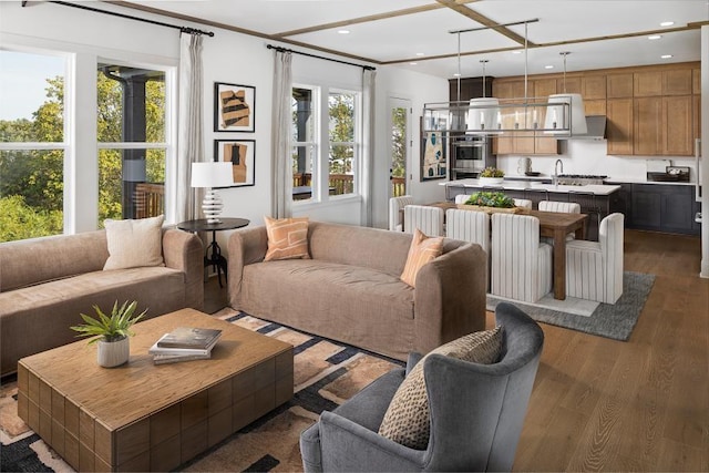 living room featuring plenty of natural light, wood finished floors, and recessed lighting