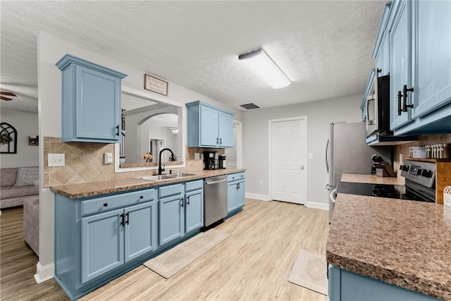 1338 Jefferson Station Rd, Jefferson, GA 30549 - kitchen with light wood-type flooring, a textured ceiling, blue cabinetry, and stainless steel appliances
