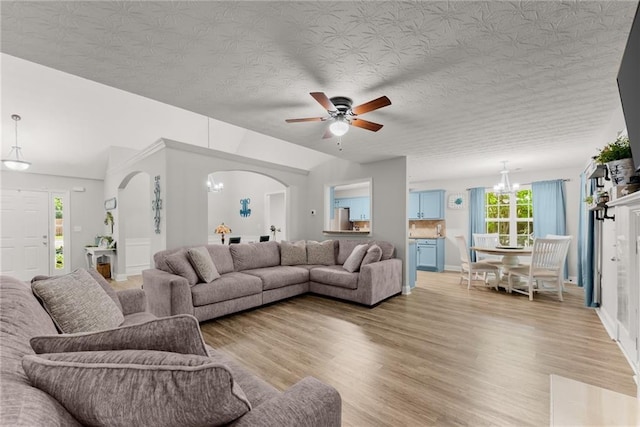 1338 Jefferson Station Rd, Jefferson, GA 30549 - living area with light wood-style floors, arched walkways, ceiling fan, and a wealth of natural light