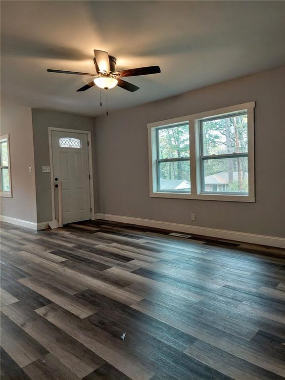 entryway with dark hardwood / wood-style flooring, ceiling fan, and plenty of natural light