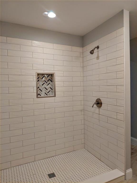 bathroom with tiled shower