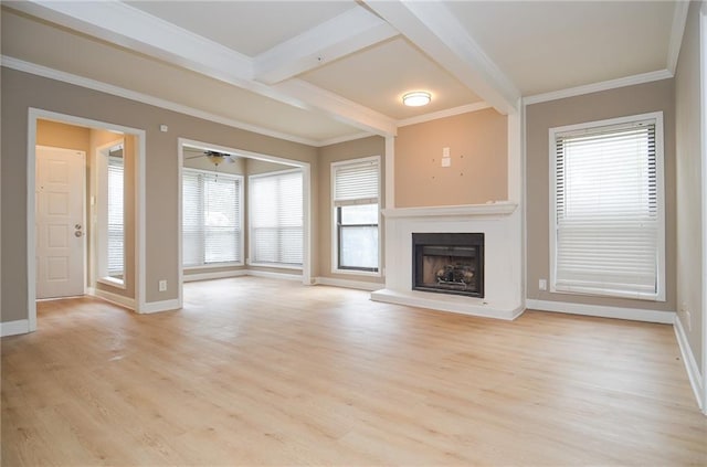 unfurnished living room featuring a fireplace with raised hearth, baseboards, light wood-type flooring, beam ceiling, and crown molding