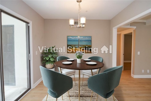 dining space with light wood-type flooring, baseboards, and an inviting chandelier