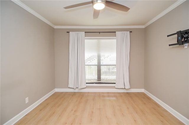 unfurnished room featuring baseboards, ornamental molding, and wood finished floors