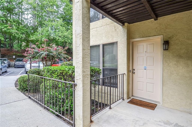 entrance to property featuring stucco siding