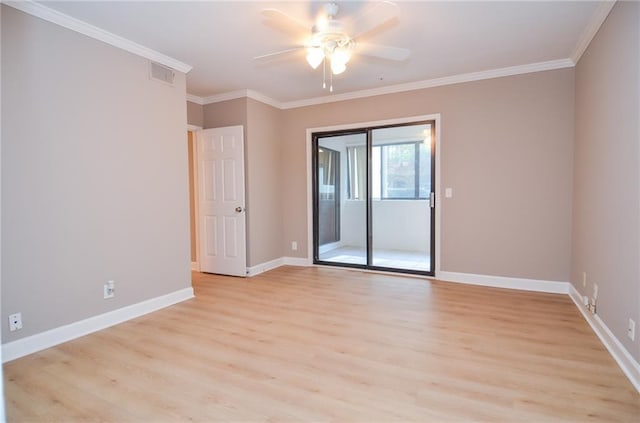 spare room with ornamental molding, light wood-style flooring, visible vents, and baseboards