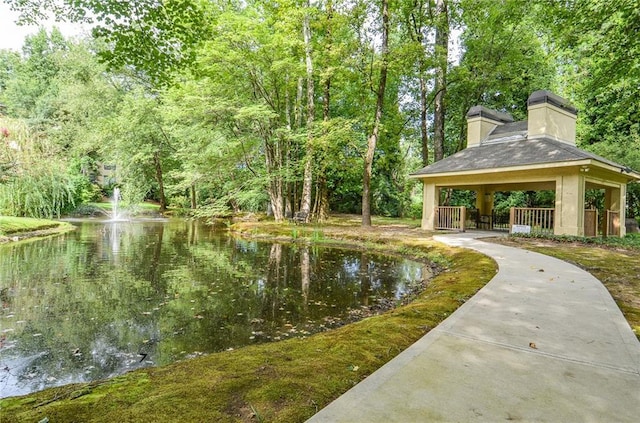 view of community with a water view and a gazebo